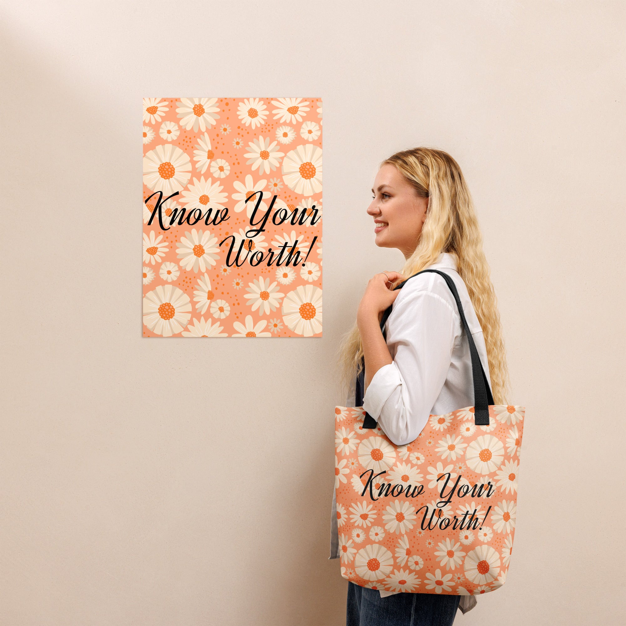All-over white daisy print tote bag with a pastel pink background “Know Your Worth” text on the front and black denim shoulder straps