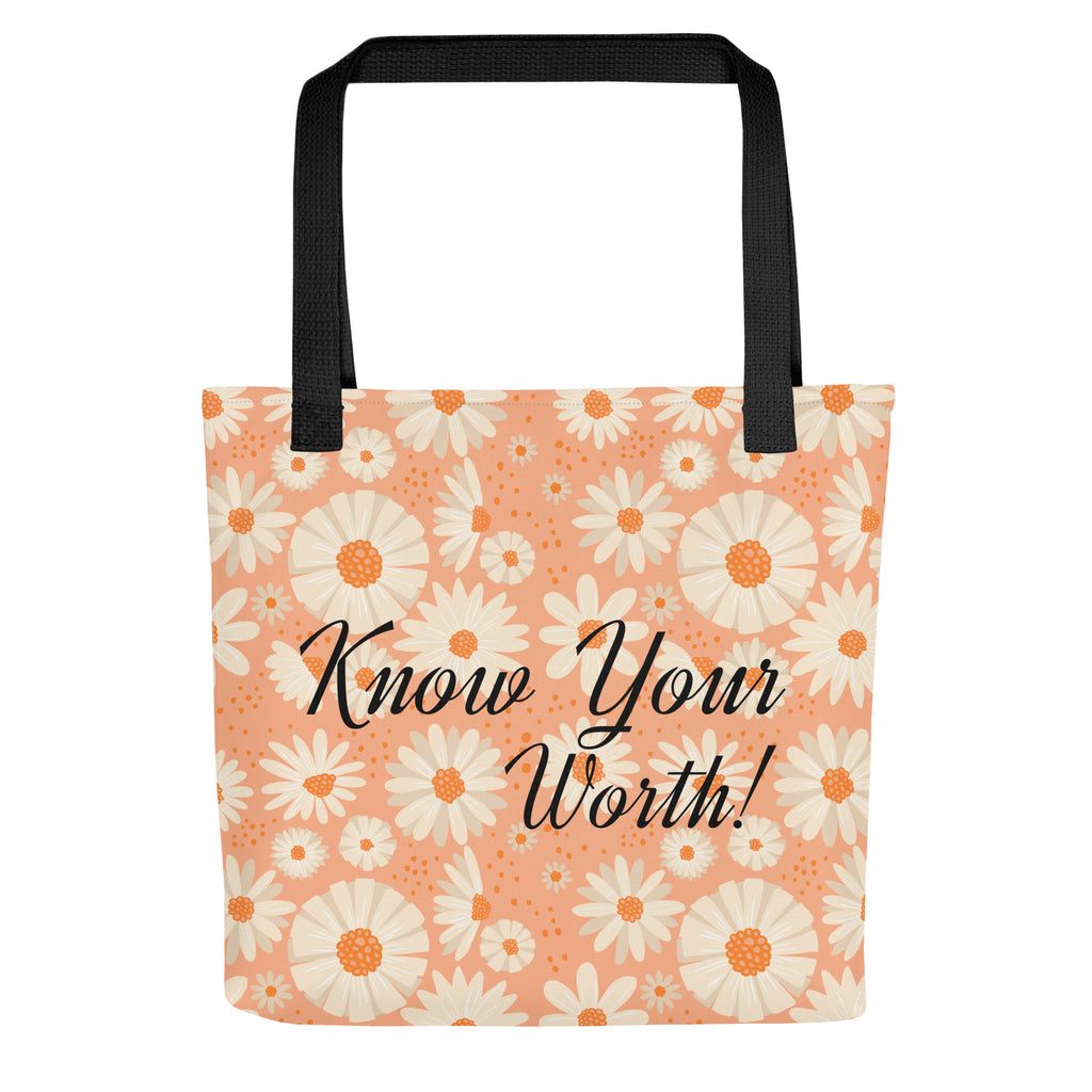 All-over white daisy print tote bag with a pastel pink background “Know Your Worth” text on the front and black denim shoulder straps