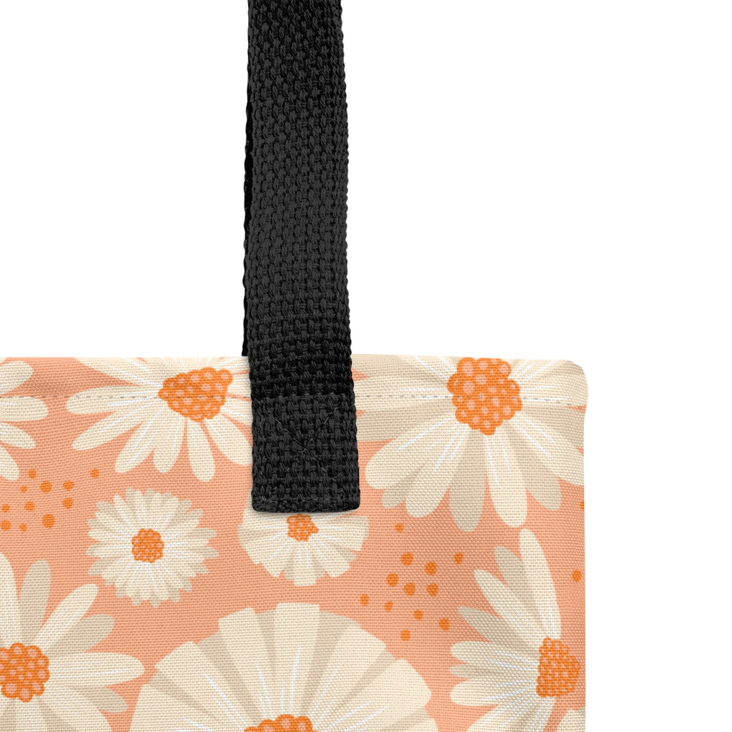 All-over white daisy print tote bag with a pastel pink background “Know Your Worth” text on the front and black denim shoulder straps
