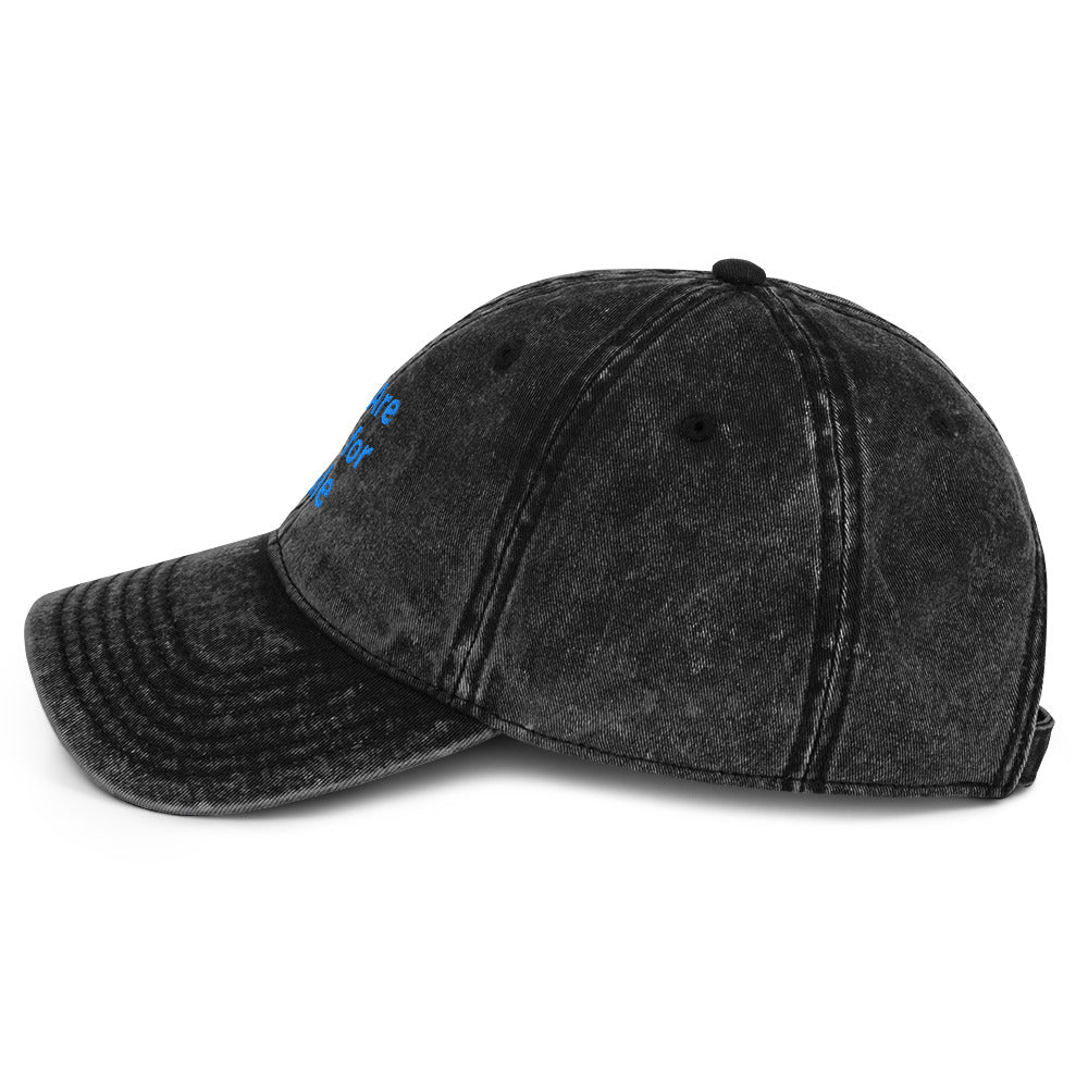 Side-view of the embroidered "We Are Not For Sale" cotton twill black stone-washed cap